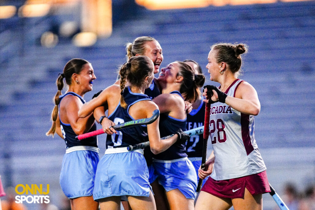 The Kean field hockey team celebrates a goal against Arcadia.